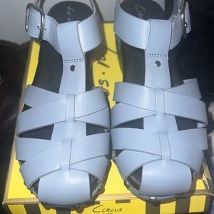 Blue Sandals with silver studs around the bottom.